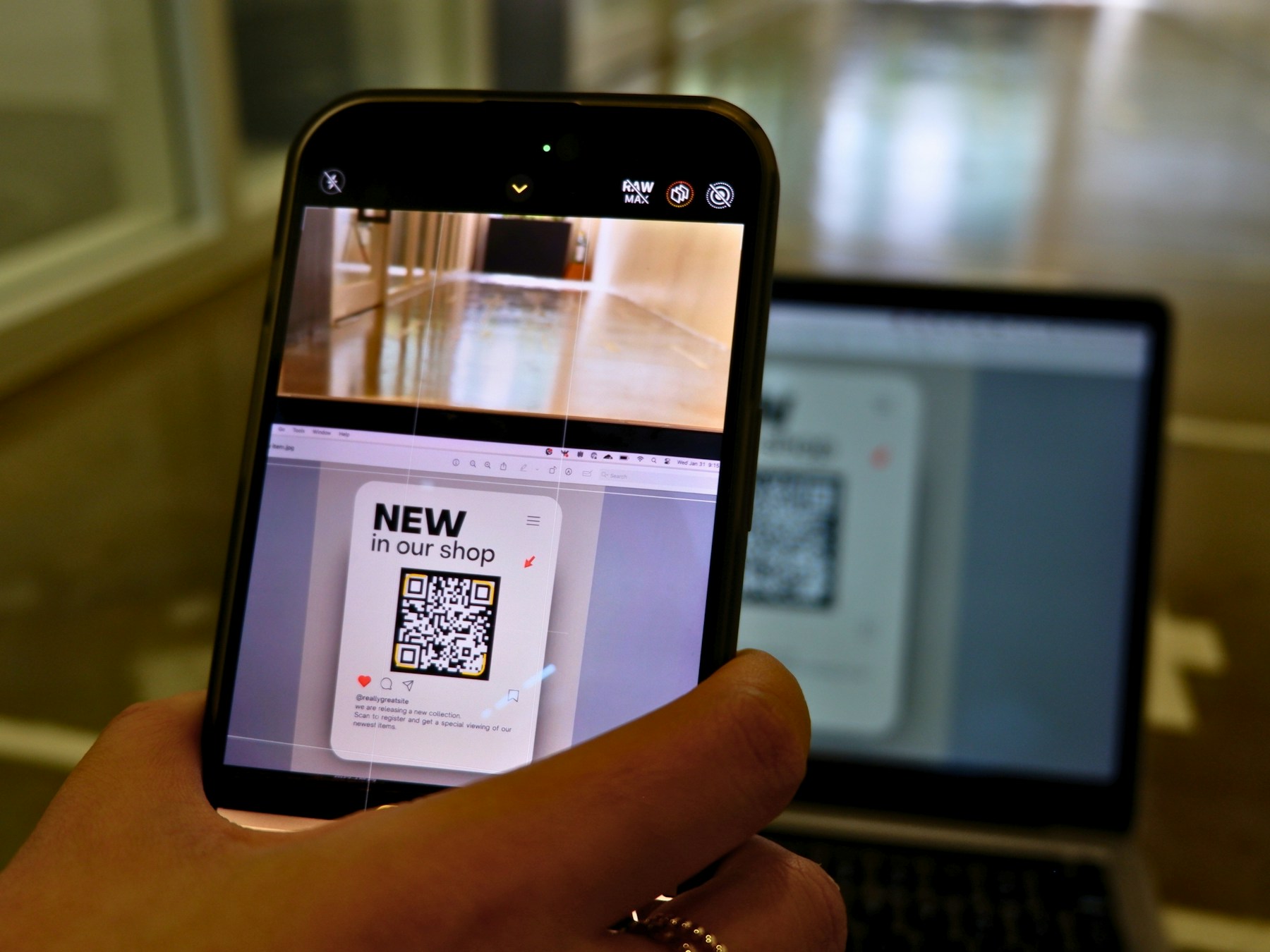 Person scanning a QR code near a laptop